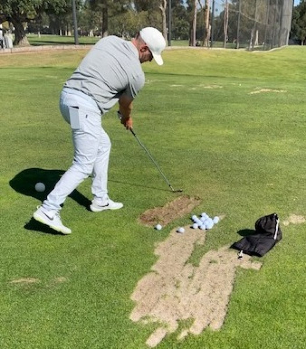 Alex Noren works on a proprietary drill designed to improve his forward shaft lean, downward strike on the ball and forward swing bottom. 